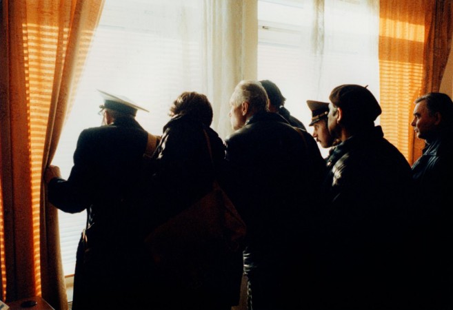 Russia, Moscow, people looking out of window, side view