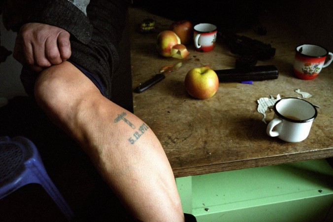 Putin's Russia - The Darkness of Russia 2002 Ussunysk Region, Russia at the Chinese border. A chinese spy who crossed over into Russia and was captured. He was imprisoned, when he was released, they tattooed his leg so he could not return to China. He became a spy for the Russians, reporting on other chinese agent, smuggling or anything criminal under soviet times. One day his handlers stopped contacting him, becoming an unemployed spy. He now smuggles goods and people across the two borders. Many people use the trains to transport suspected goods to Moscow and the rest of Russia.